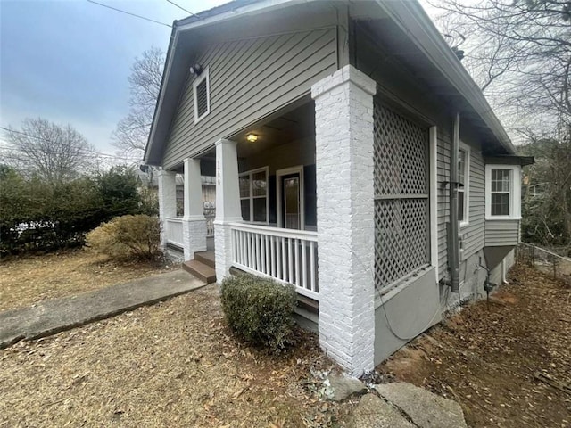 view of side of home featuring a porch