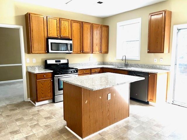 kitchen featuring a center island, sink, and stainless steel appliances