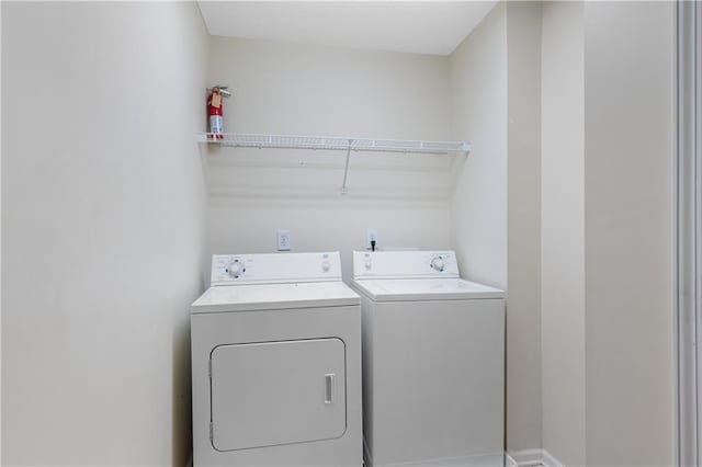 laundry room featuring washing machine and clothes dryer