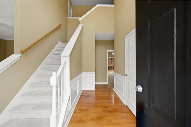 foyer entrance featuring ornamental molding and light hardwood / wood-style flooring