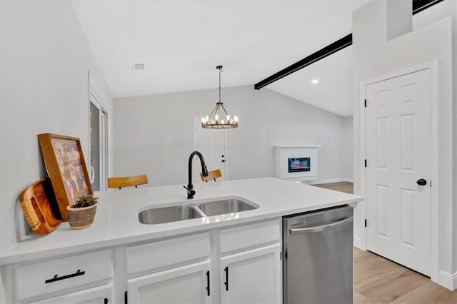 kitchen with visible vents, dishwasher, light countertops, white cabinetry, and a sink