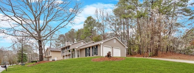 view of front of property with a front yard, a garage, and a chimney