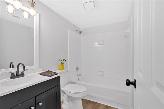 full bathroom with vanity,  shower combination, toilet, and wood finished floors