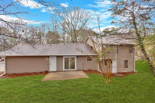 rear view of house featuring a patio area and a lawn