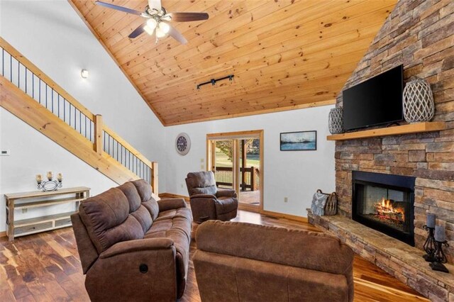 living room with a stone fireplace, dark wood-type flooring, wooden ceiling, high vaulted ceiling, and ceiling fan