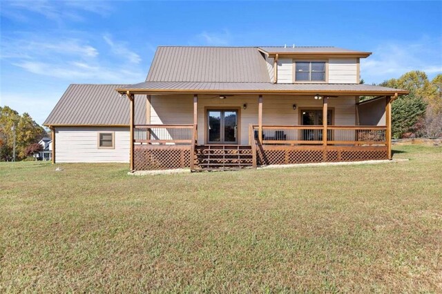 back of house with a lawn and a porch