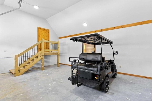 workout area with concrete flooring and vaulted ceiling