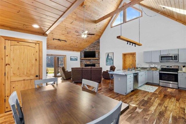 dining space with beam ceiling, dark hardwood / wood-style floors, high vaulted ceiling, and wooden ceiling