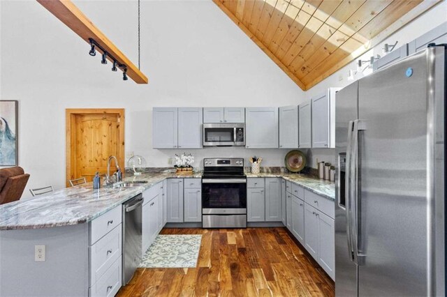 kitchen with light stone countertops, high vaulted ceiling, wooden ceiling, dark wood-type flooring, and stainless steel appliances