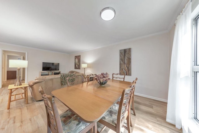 1111 Clairemont Ave Unit N3, Decatur, GA 30030 - dining space featuring light wood-type flooring, crown molding, plenty of natural light, and baseboards