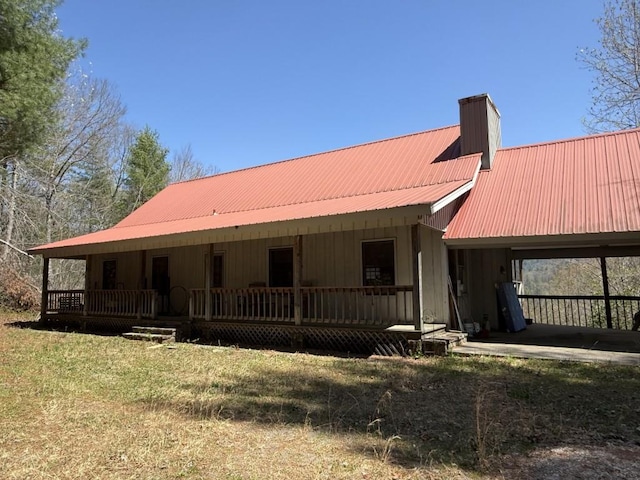 8578 Soapstone Creek Cir, Hiawassee, GA 30546 - country-style home featuring a porch, metal roof, a chimney, and a front yard