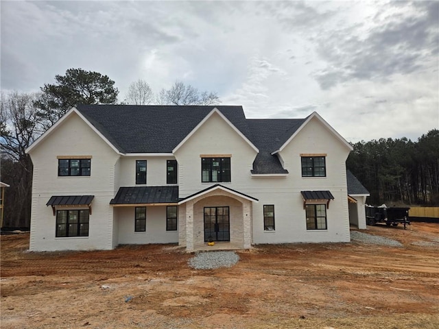 modern farmhouse style home featuring metal roof and a standing seam roof