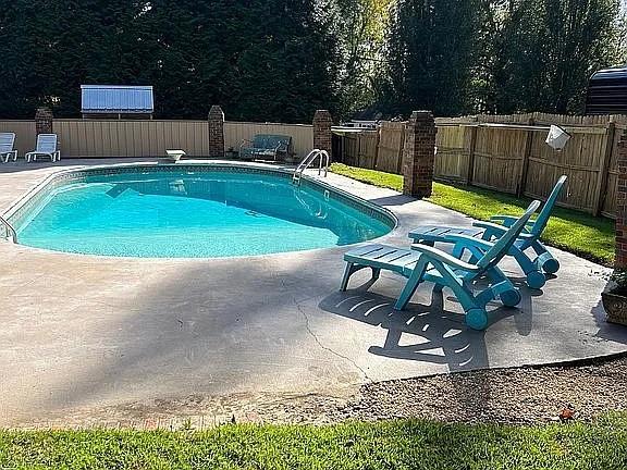 view of pool featuring a fenced backyard, a fenced in pool, and a patio
