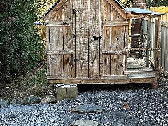 entry to storm shelter featuring an outbuilding