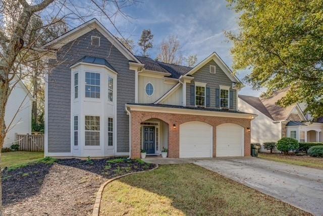 view of front of property with a garage and a front lawn