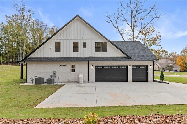 view of home's exterior featuring a lawn, central AC, and a garage