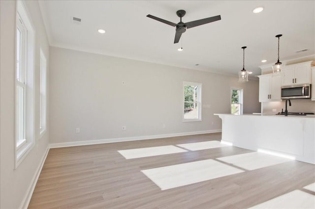 101 Priestwood Ln, Acworth, GA 30102 - unfurnished living room with light wood-type flooring, recessed lighting, baseboards, ceiling fan, and ornamental molding