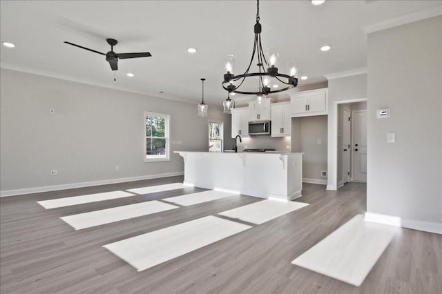 101 Priestwood Ln, Acworth, GA 30102 - unfurnished living room featuring baseboards, ornamental molding, light wood finished floors, a chandelier, and recessed lighting