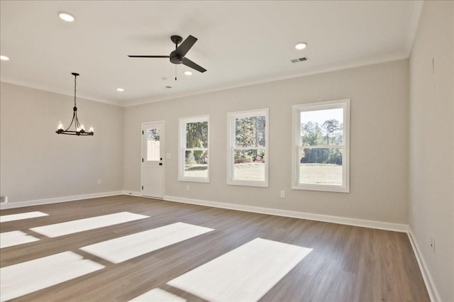 101 Priestwood Ln, Acworth, GA 30102 - unfurnished living room with wood finished floors, ornamental molding, baseboards, a chandelier, and a ceiling fan