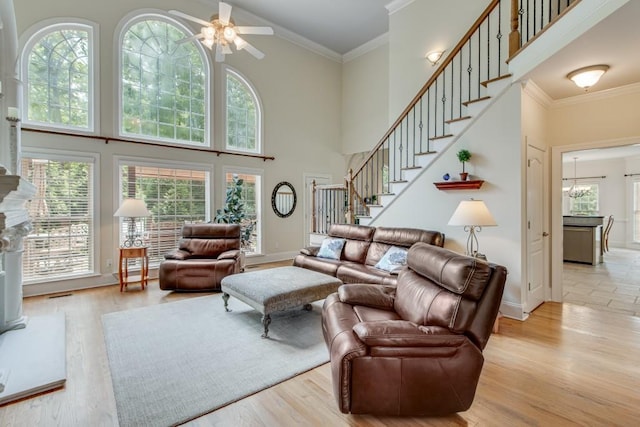5359 Point S Dr, Gainesville, GA 30504 - living room featuring a high ceiling, a ceiling fan, stairs, ornamental molding, and light wood-style floors