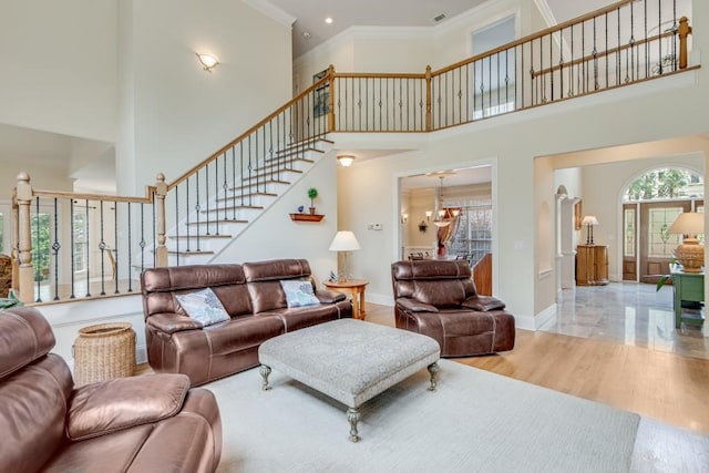 5359 Point S Dr, Gainesville, GA 30504 - living area featuring crown molding, stairway, a chandelier, and a high ceiling