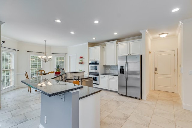 5359 Point S Dr, Gainesville, GA 30504 - kitchen with stainless steel appliances, ornamental molding, dark stone countertops, white cabinets, and recessed lighting