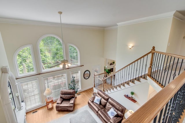 5359 Point S Dr, Gainesville, GA 30504 - living area featuring wood finished floors, a high ceiling, ornamental molding, stairway, and ceiling fan