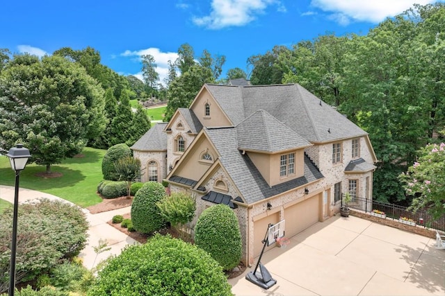 5359 Point S Dr, Gainesville, GA 30504 - french country inspired facade with an attached garage, stucco siding, concrete driveway, a shingled roof, and view of wooded area