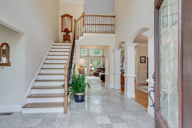 5359 Point S Dr, Gainesville, GA 30504 - entryway featuring a high ceiling, arched walkways, stairs, decorative columns, and marble finish flooring