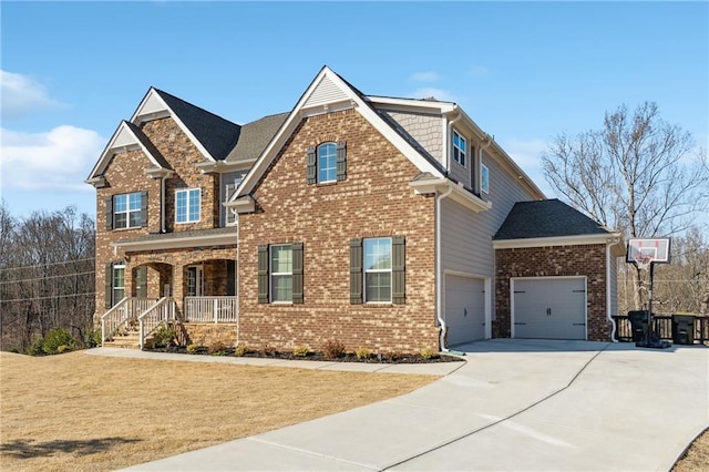 craftsman house with a porch, concrete driveway, and brick siding