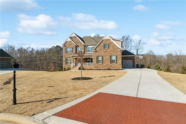 view of front of home with a garage, a front lawn, concrete driveway, and brick siding