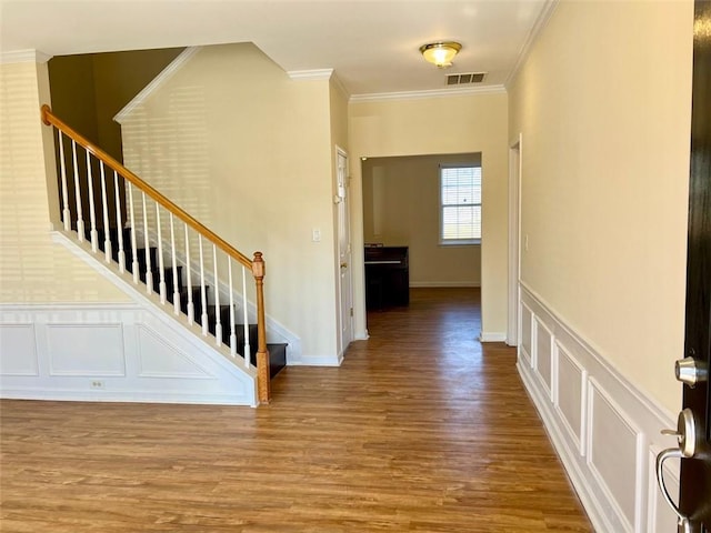 interior space with ornamental molding and wood-type flooring