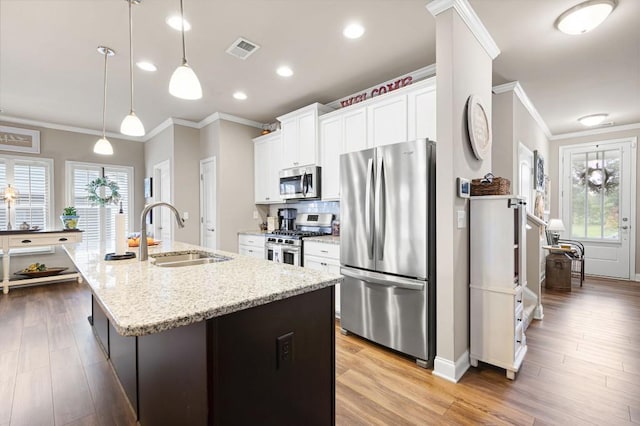 80 Azalea Xing, Dallas, GA 30132 - kitchen featuring appliances with stainless steel finishes, a sink, crown molding, an island with sink, and white cabinets