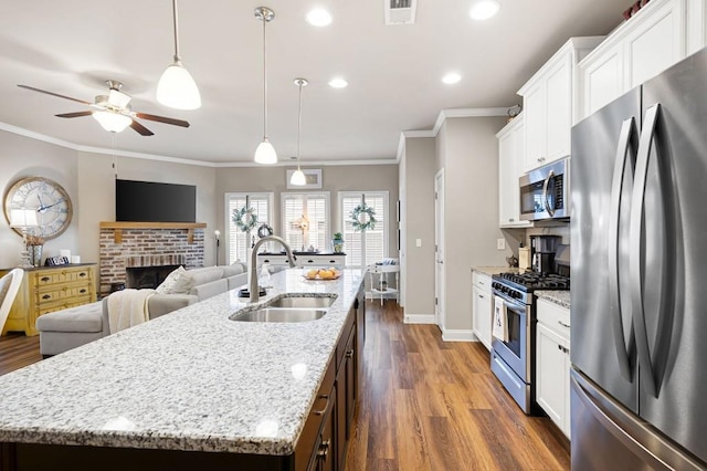 80 Azalea Xing, Dallas, GA 30132 - kitchen with stainless steel appliances, a sink, ceiling fan, a brick fireplace, and baseboards