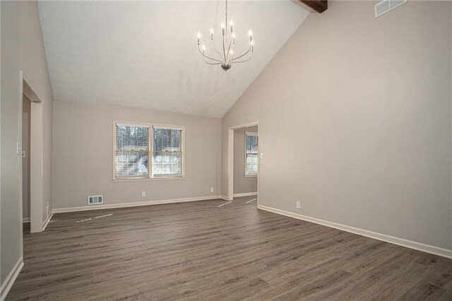 1312 La Mesa Dr, Lawrenceville, GA 30043 - empty room featuring a chandelier, dark wood finished floors, high vaulted ceiling, baseboards, and beam ceiling