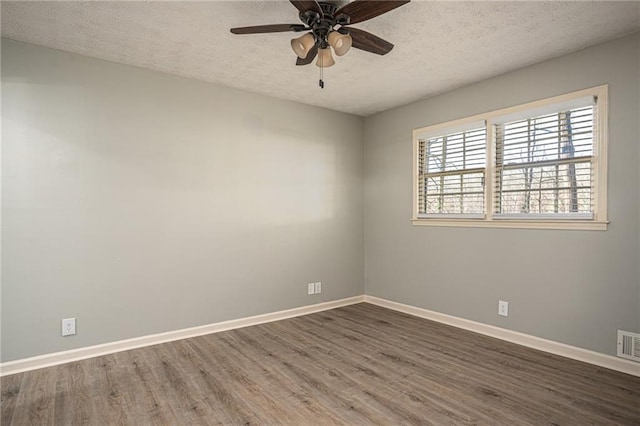 1312 La Mesa Dr, Lawrenceville, GA 30043 - spare room featuring wood finished floors, a textured ceiling, baseboards, and a ceiling fan