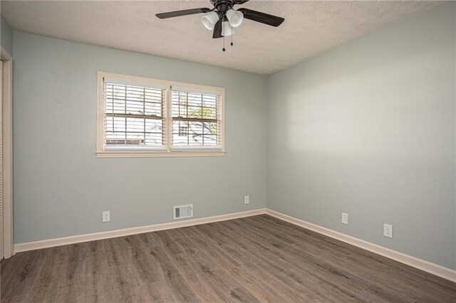 1312 La Mesa Dr, Lawrenceville, GA 30043 - empty room with a textured ceiling, wood finished floors, ceiling fan, and baseboards