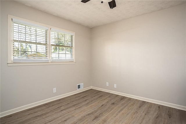 1312 La Mesa Dr, Lawrenceville, GA 30043 - unfurnished room with wood finished floors, a textured ceiling, baseboards, and ceiling fan