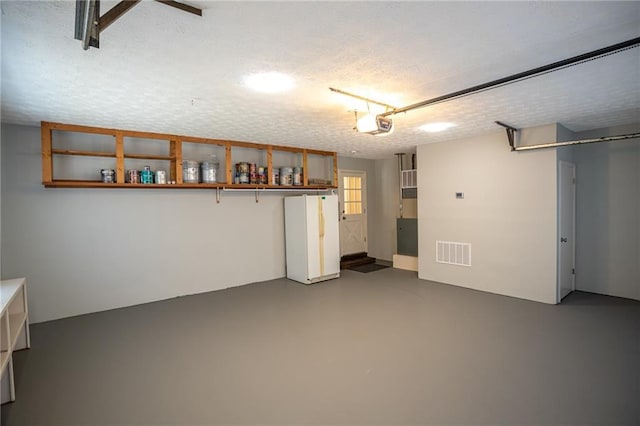 1312 La Mesa Dr, Lawrenceville, GA 30043 - garage with freestanding refrigerator and a garage door opener