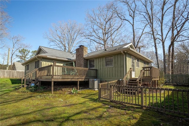 1312 La Mesa Dr, Lawrenceville, GA 30043 - rear view of house with a deck, central AC unit, stairway, and a chimney