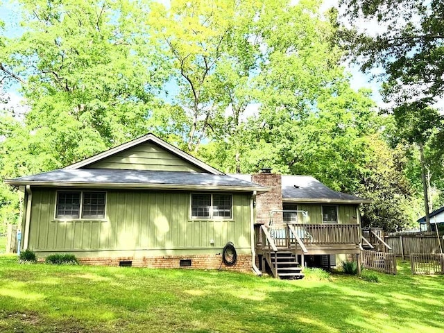 1312 La Mesa Dr, Lawrenceville, GA 30043 - back of property featuring a deck, crawl space, stairs, board and batten siding, and a chimney