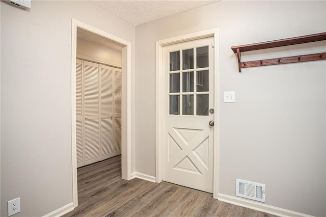 1312 La Mesa Dr, Lawrenceville, GA 30043 - doorway featuring wood finished floors, baseboards, and a textured ceiling