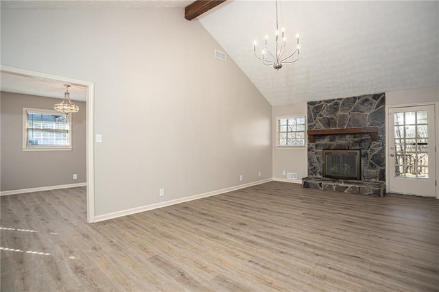 1312 La Mesa Dr, Lawrenceville, GA 30043 - unfurnished living room featuring a chandelier, beam ceiling, wood finished floors, a fireplace, and high vaulted ceiling