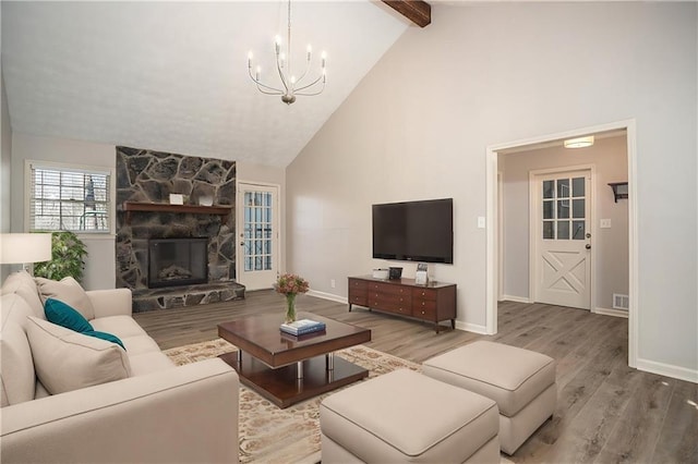 1312 La Mesa Dr, Lawrenceville, GA 30043 - living area featuring a chandelier, wood finished floors, beam ceiling, high vaulted ceiling, and a stone fireplace