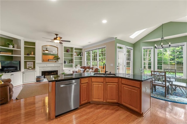 1995 Settindown Dr, Roswell, GA 30075 - kitchen with dishwasher, open floor plan, a fireplace, light wood finished floors, and a kitchen island with sink