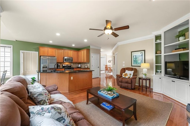 1995 Settindown Dr, Roswell, GA 30075 - living area featuring ceiling fan, light wood-style flooring, ornamental molding, and recessed lighting