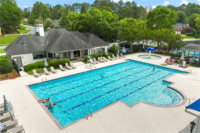 1995 Settindown Dr, Roswell, GA 30075 - community pool featuring a patio, a jacuzzi, and view of wooded area