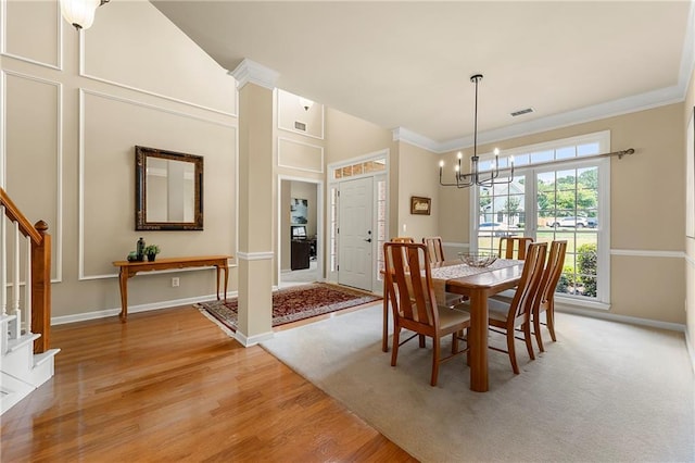 1995 Settindown Dr, Roswell, GA 30075 - dining area featuring stairway, a chandelier, crown molding, and light wood finished floors