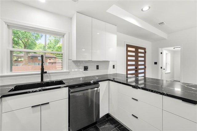 kitchen with dishwasher, backsplash, white cabinetry, and sink