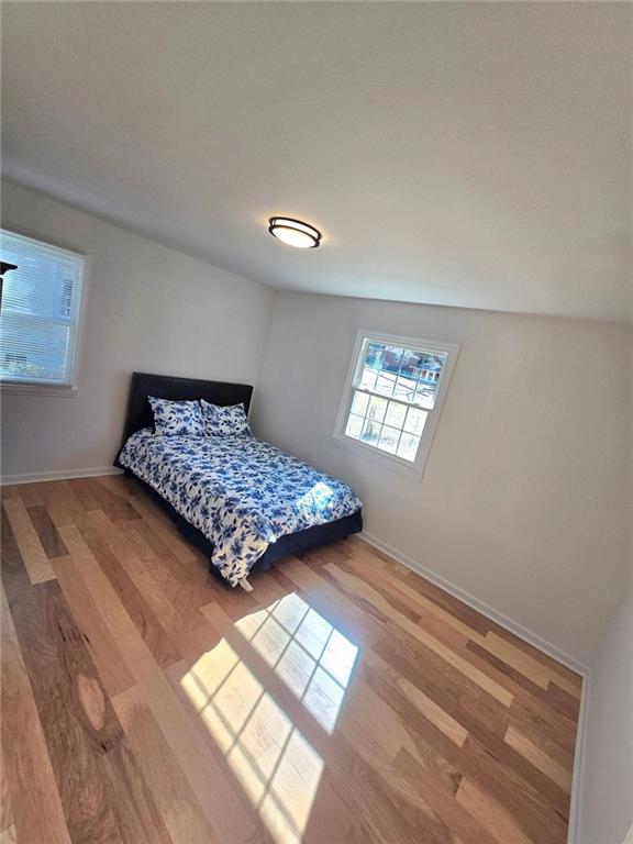 bedroom featuring baseboards and light wood-style floors